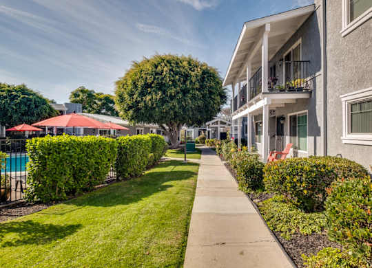 A sunny day at a residential area with apartment buildings and greenery.