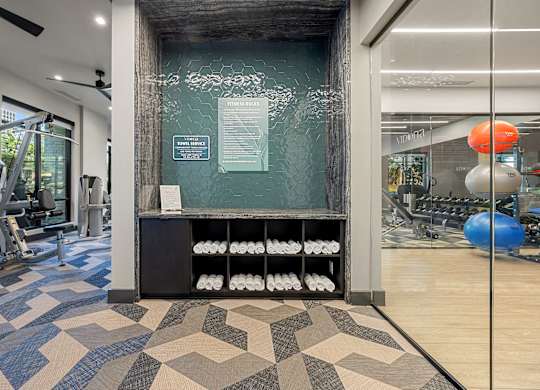 A gym with a variety of equipment and a sign on the wall.