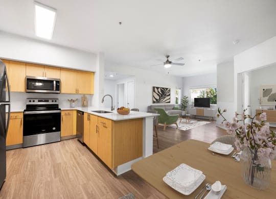 a kitchen and living room with wooden floors and a table