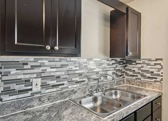 A kitchen with a sink and cabinets.