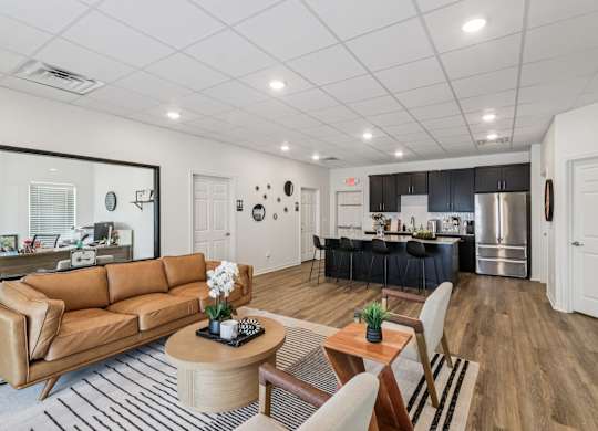 A modern living room with a brown leather couch and a wooden coffee table.