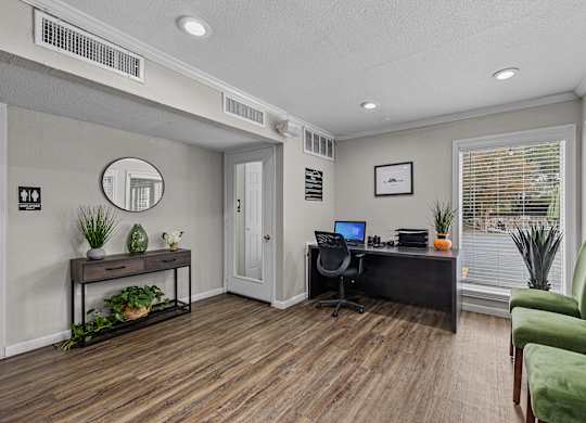 a home office with a desk and a chair and a window