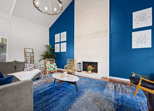 a living room with blue walls and a fireplace