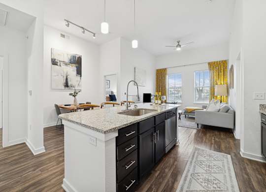 A kitchen with a large island and a dining table.