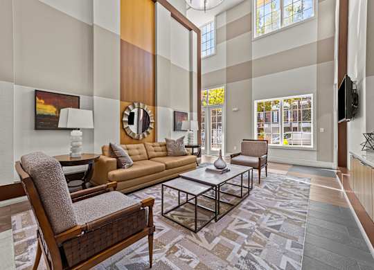 a living room with couches and chairs and a table