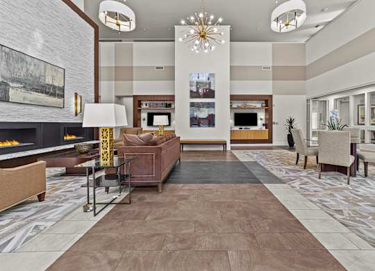 a lobby with couches chairs and a fireplace