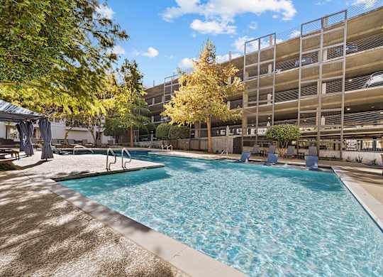 a swimming pool in front of an apartment building