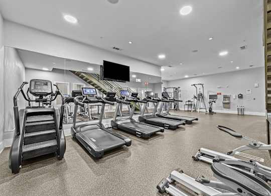 a gym with cardio equipment and treadmills