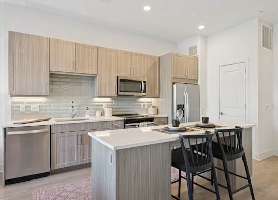 A modern kitchen with a white countertop and wooden cabinets.