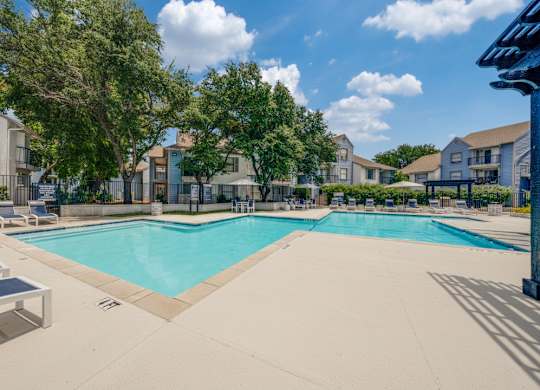 A large swimming pool surrounded by residential buildings.