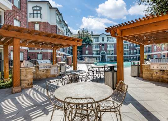 an outdoor patio with tables and chairs and a pool