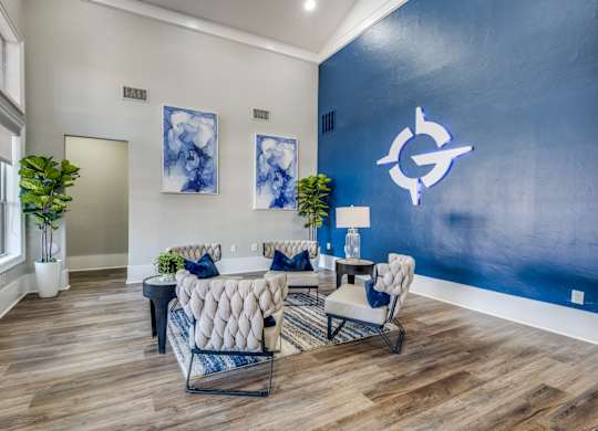 a living room with a blue wall and white furniture