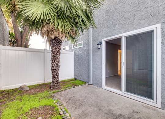 A white door is open to a room with a glass window.