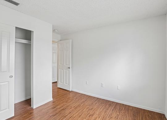 A room with white walls and wooden flooring.