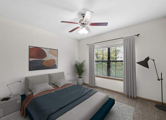 A bedroom with a bed, a ceiling fan, and a window with a plant.