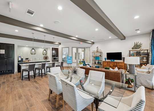 A modern living room with a dining area and a kitchen in the background.