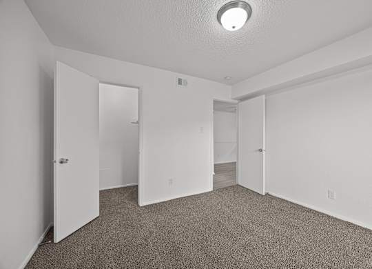 A room with carpeted floor and white walls.