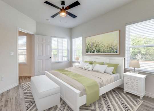 a bedroom with a large bed and a ceiling fan