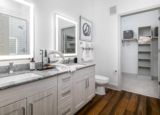 A bathroom with a white toilet, a sink, and a mirror.