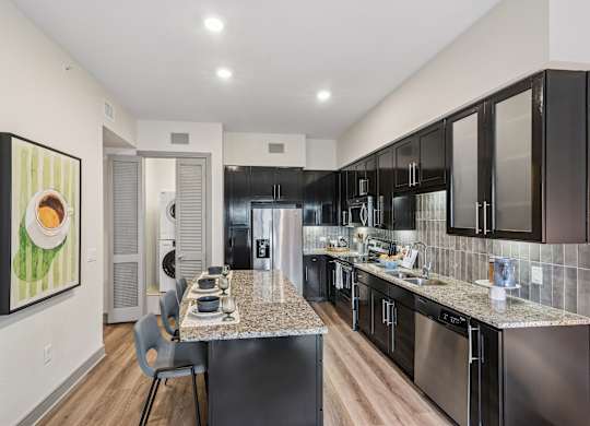 A modern kitchen with a dining table and chairs.