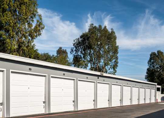 A row of white garage doors are closed.