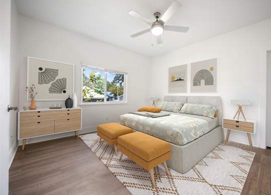 A bedroom with a bed, a dresser, and a ceiling fan.
