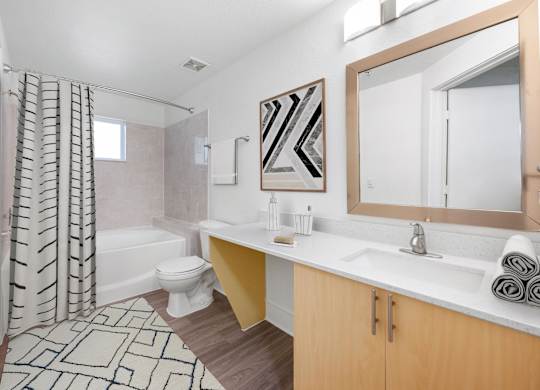 A bathroom with a toilet, sink, and shower.