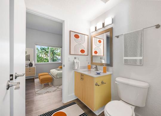 A bathroom with a yellow cabinet and a white toilet.