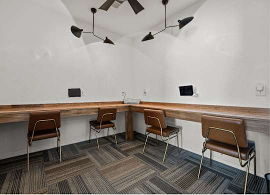 a long wooden table with chairs in a room