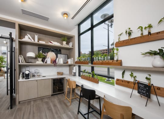 a kitchen with white countertops and a large window