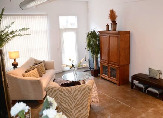 a living room filled with furniture and a large window