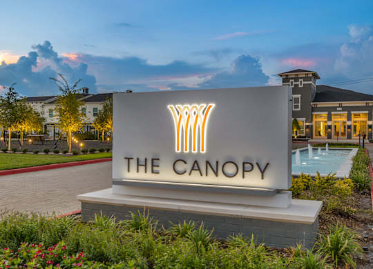 The Canopy sign is lit up at dusk.
