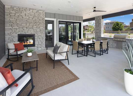 A patio with a fireplace and furniture.