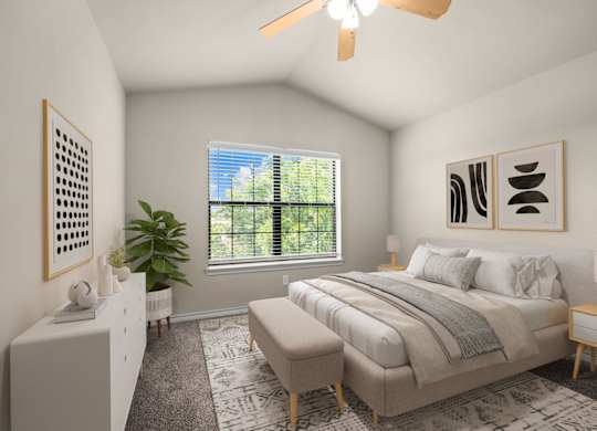 A bedroom with a large bed and a ceiling fan.