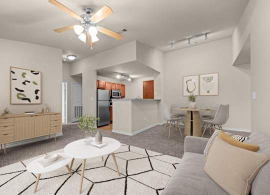 A modern living room with a grey couch and a white coffee table.