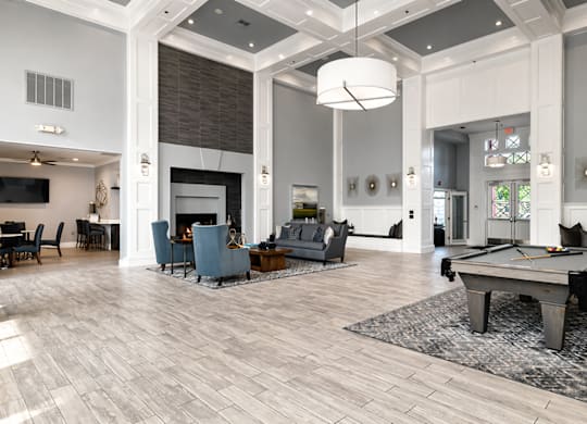 A large room with a pool table and a fireplace.