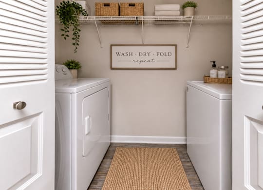 A laundry room with a sign that says