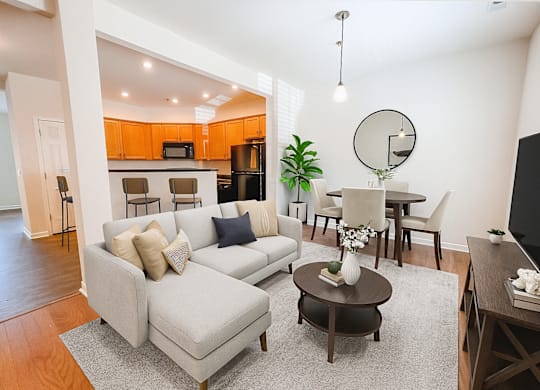 A living room with a grey couch and a coffee table.