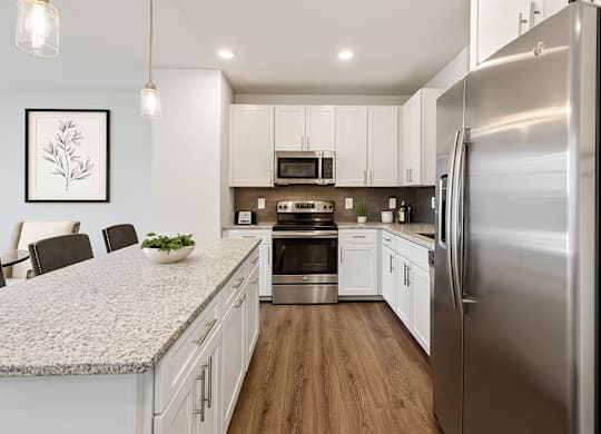 A modern kitchen with a refrigerator on the right.