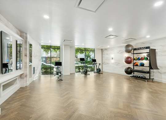 A room with wooden floors and a white ceiling with lights.