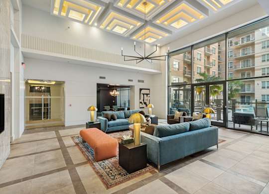 A spacious living room with a large sectional sofa and a rug.