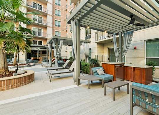 A patio with a table and chairs under a roof.
