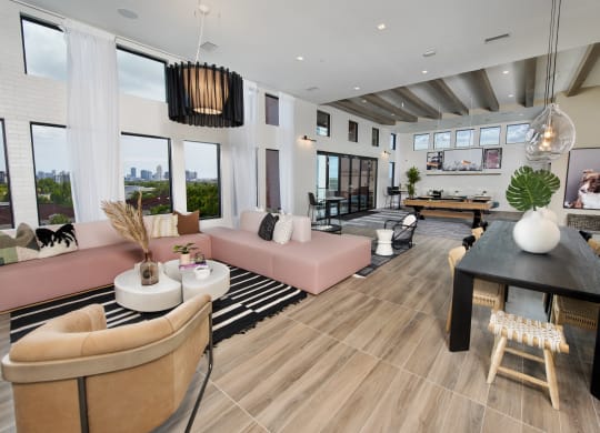 a living room with couches and a table with a ping pong