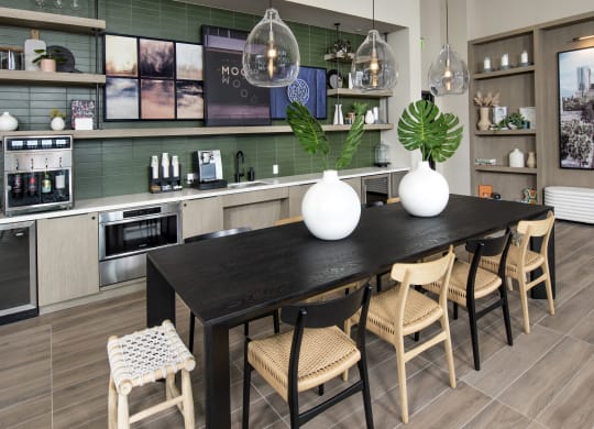 a kitchen and dining room with a table and chairs