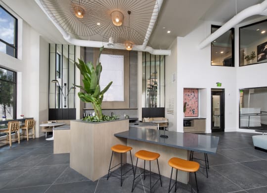 a lobby with a table and four stools