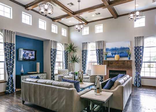 A living room with a couch, a television, and a fireplace.