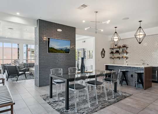 A modern dining room with a glass table and chairs.