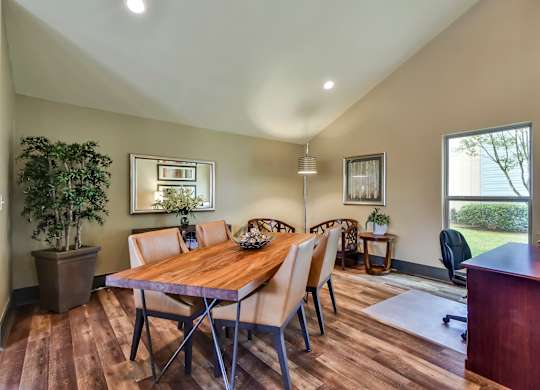 A dining room with a wooden table and chairs.