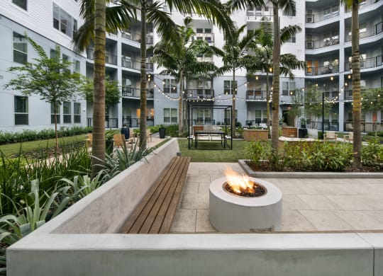 a fire pit in the courtyard of an apartment building