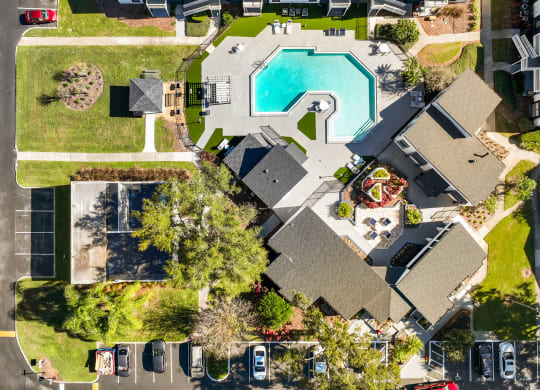 an aerial view of a house with a swimming pool in the backyard